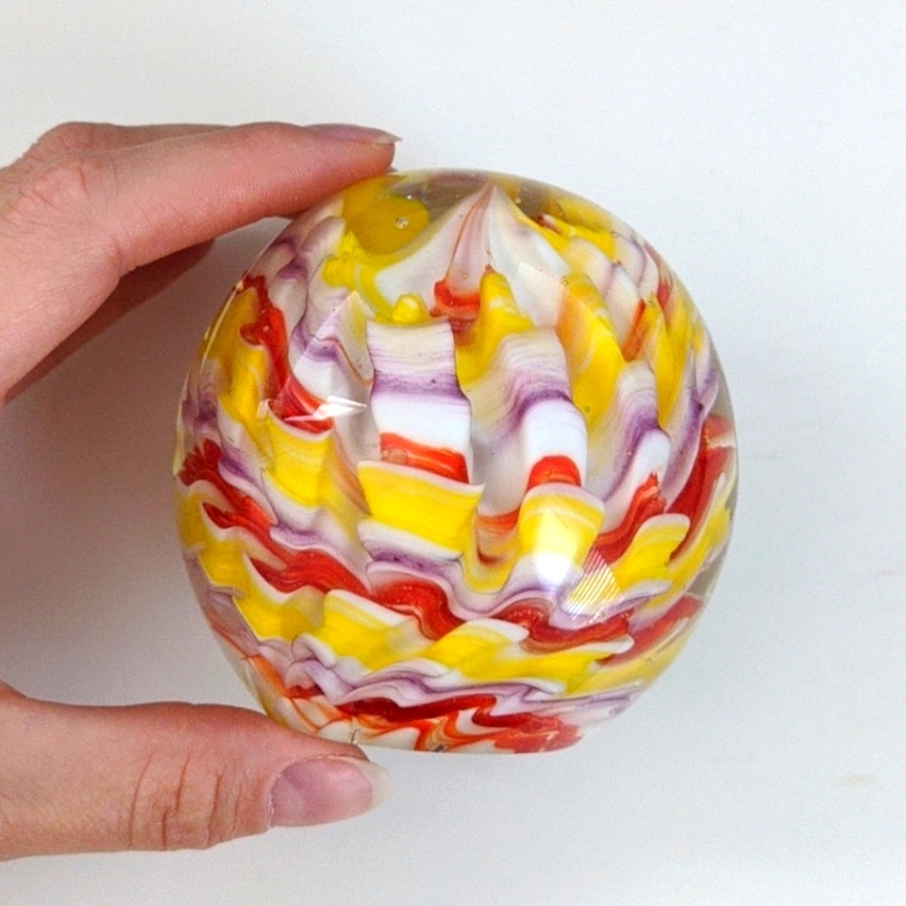 Yellow, red, purple, and white paperweight
